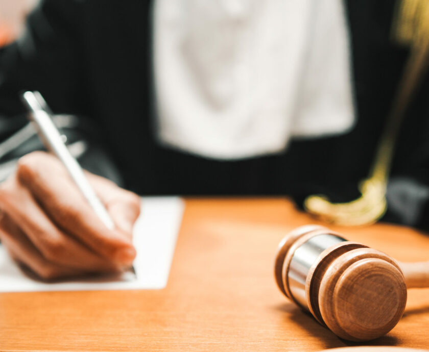 Judge reads the sentence to be afflicted on the criminal in the courtroom